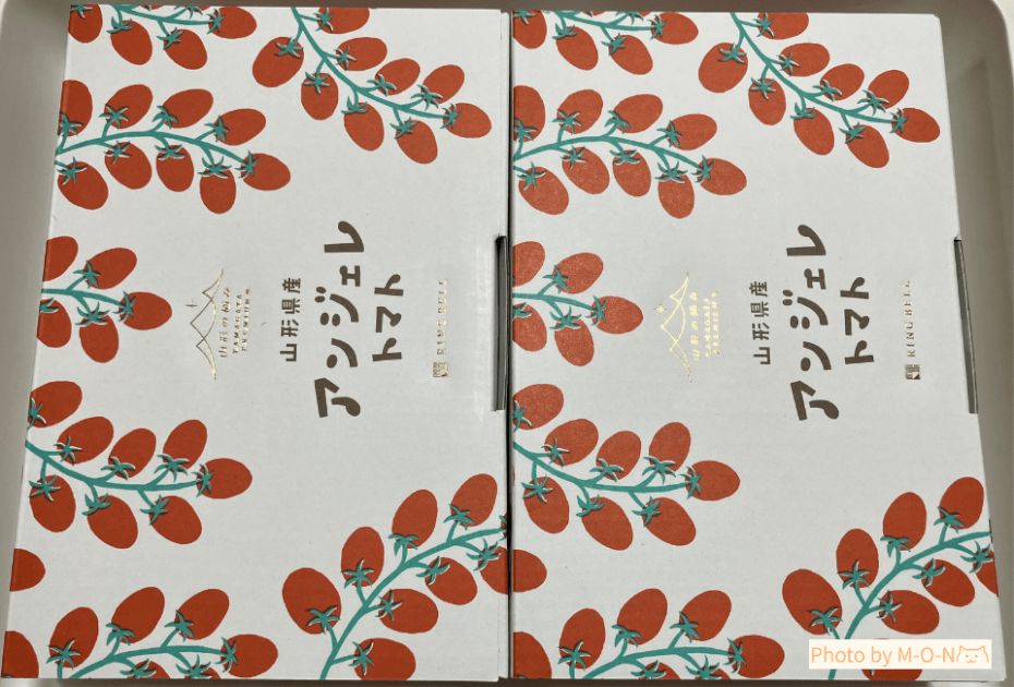 ヒューリック優待で頼んだ山形県産ミニトマトアンジェレのトマトのイラストが描かれた箱